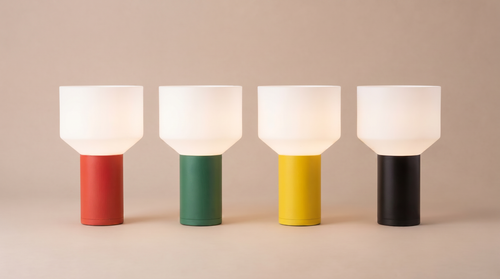 Four colorful lamps with different colored bases on a beige background